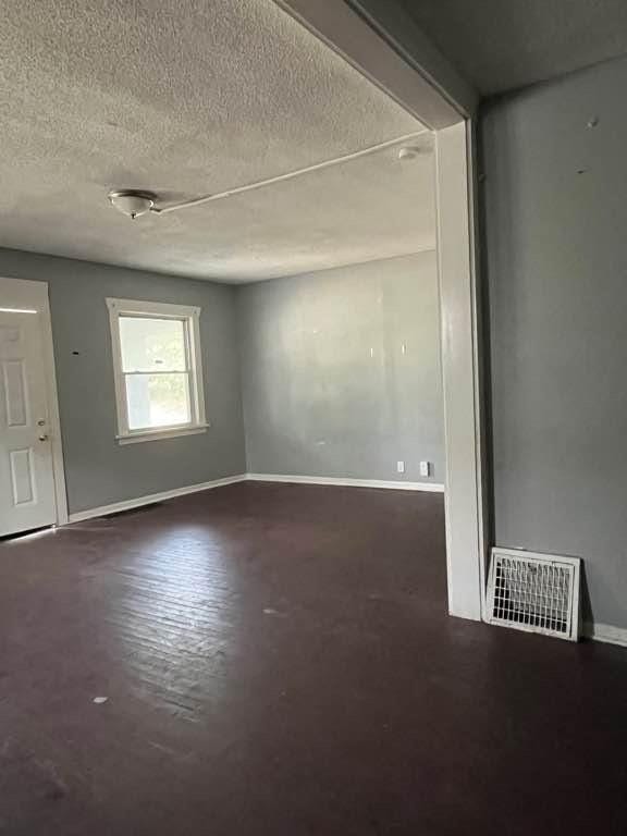 empty room featuring a textured ceiling