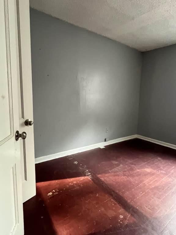 spare room with a textured ceiling