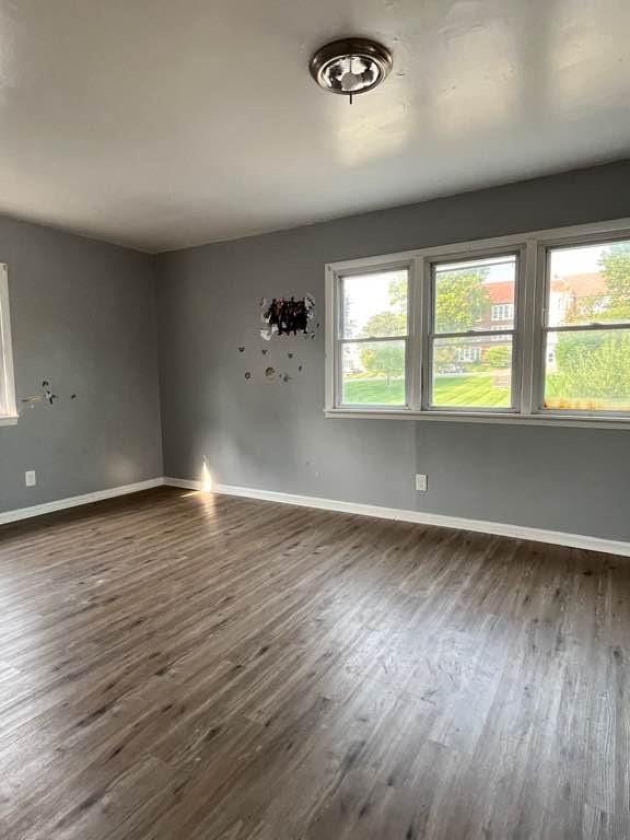 unfurnished room featuring dark hardwood / wood-style flooring