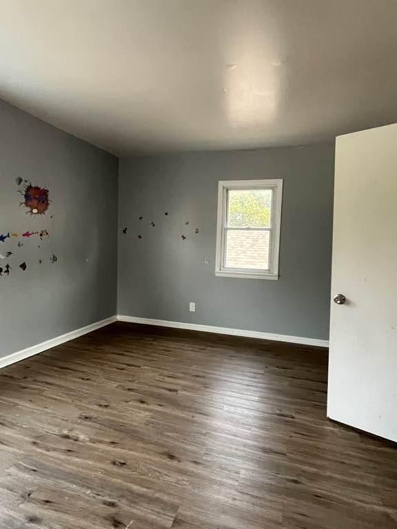 unfurnished room featuring dark hardwood / wood-style flooring