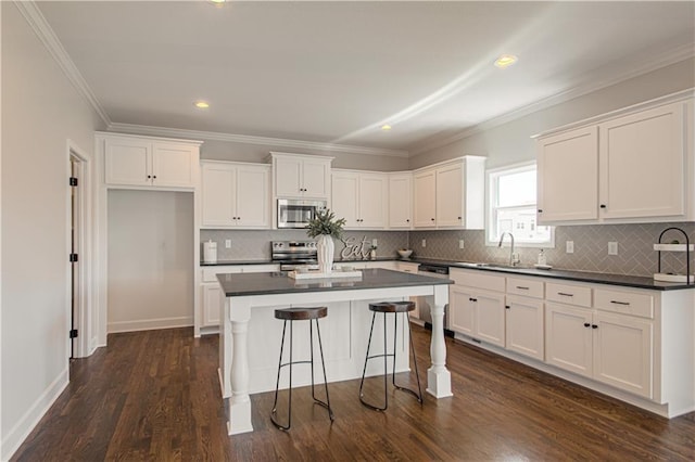 kitchen with white cabinetry, stainless steel appliances, dark hardwood / wood-style floors, and sink