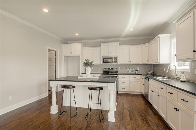 kitchen with dark wood-type flooring, white cabinetry, sink, and stainless steel appliances