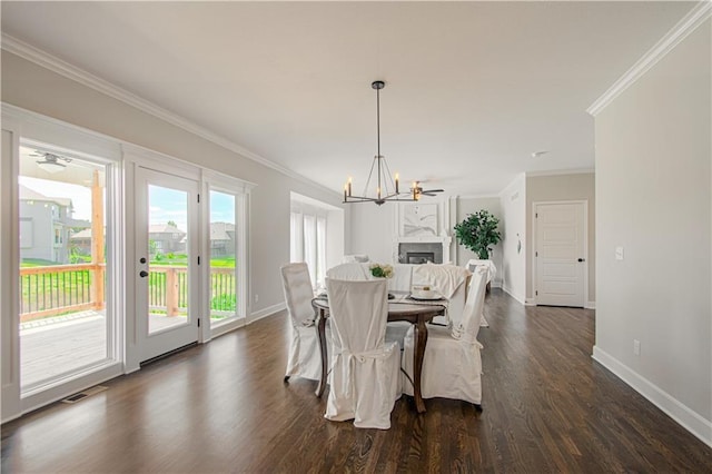 dining room featuring dark hardwood / wood-style floors, ceiling fan with notable chandelier, and ornamental molding