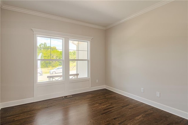 unfurnished room featuring dark wood-type flooring and ornamental molding