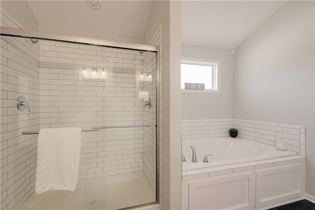 bathroom with plus walk in shower and lofted ceiling