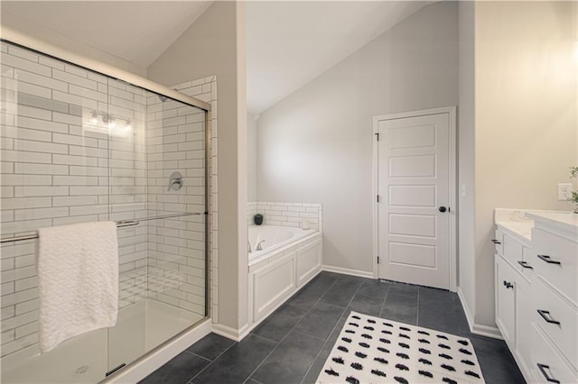 bathroom with vanity, shower with separate bathtub, tile patterned floors, and vaulted ceiling