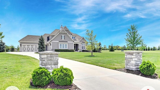 view of front of property featuring a front lawn and a garage