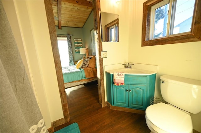 bathroom featuring hardwood / wood-style floors, vanity, lofted ceiling with beams, toilet, and wood ceiling