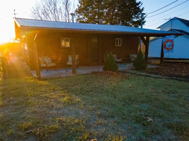 back of property featuring a lawn