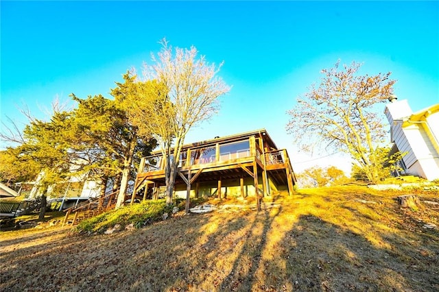 back of house featuring a wooden deck