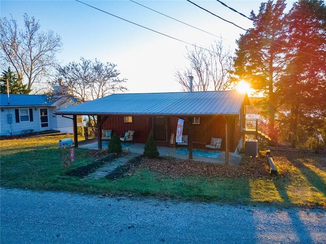 ranch-style home with a front yard and central AC