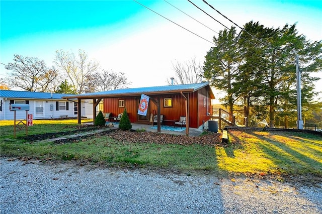 view of front of house featuring a front lawn and central air condition unit