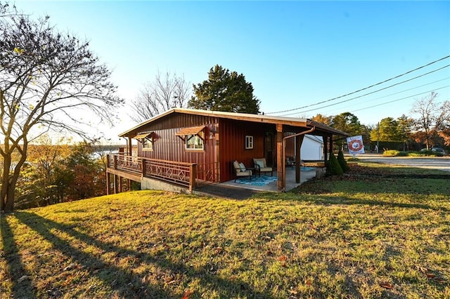 view of side of home featuring a yard and a patio