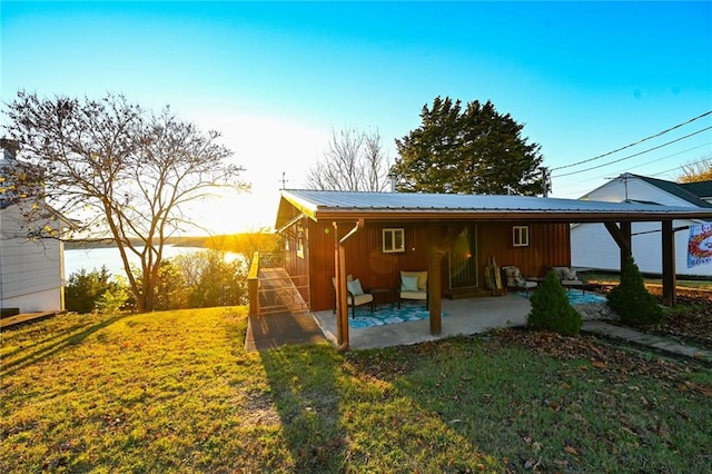 view of side of property with a patio area and a yard