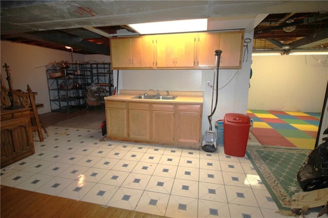 basement featuring sink and light wood-type flooring