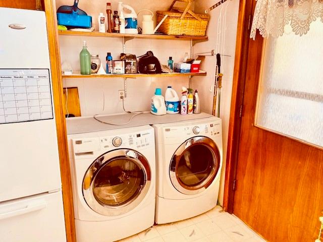 clothes washing area with independent washer and dryer