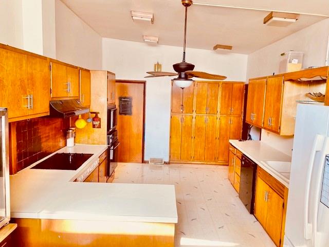 kitchen featuring black appliances, ceiling fan, and tasteful backsplash