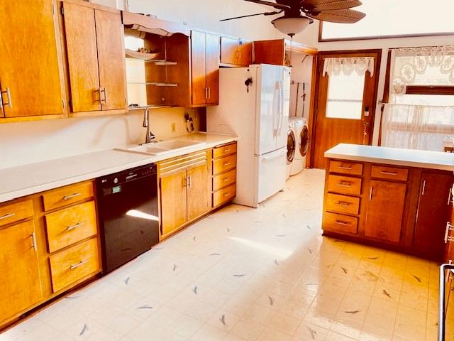 kitchen with sink, ceiling fan, washer and clothes dryer, white refrigerator, and black dishwasher