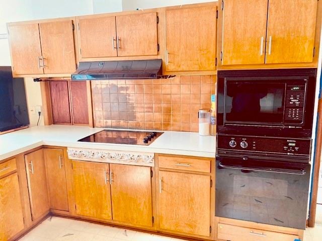 kitchen with backsplash and black appliances