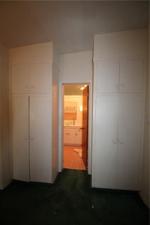 unfurnished bedroom with ensuite bathroom and a closet