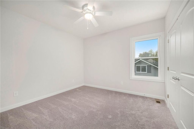 carpeted empty room featuring ceiling fan