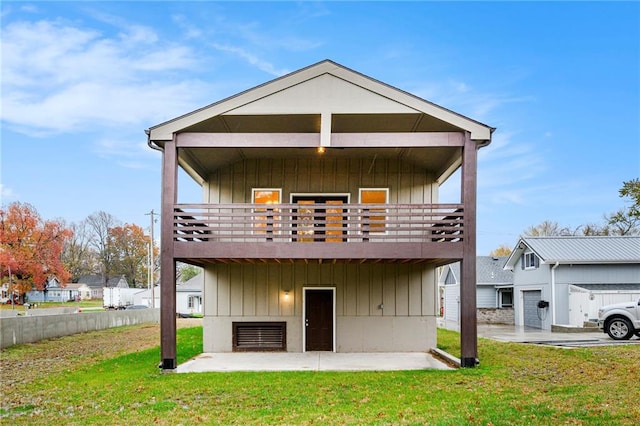 rear view of house featuring a lawn, a patio area, and a deck