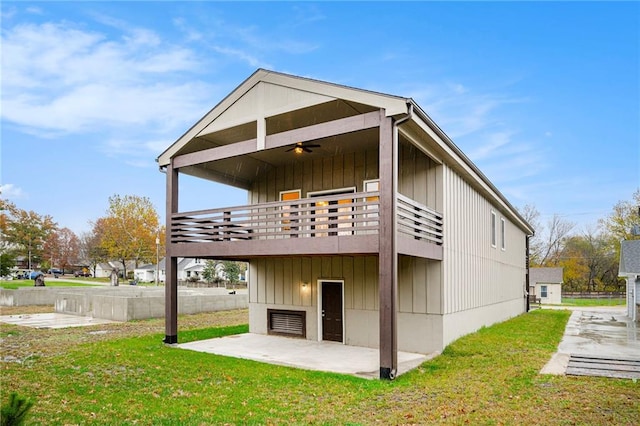 rear view of property with a lawn, ceiling fan, a patio area, and a wooden deck