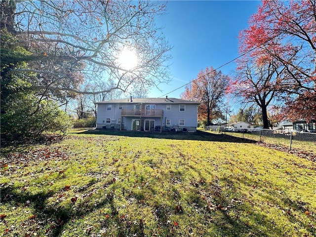 back of property featuring a yard