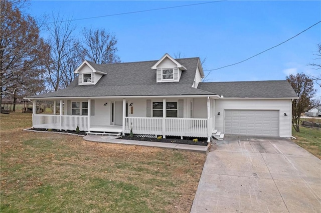 view of front of house featuring covered porch, a front yard, and a garage