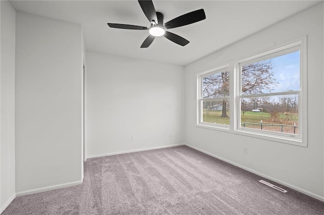 spare room with light carpet and ceiling fan