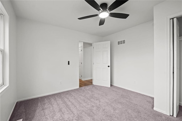 unfurnished bedroom featuring carpet flooring and ceiling fan