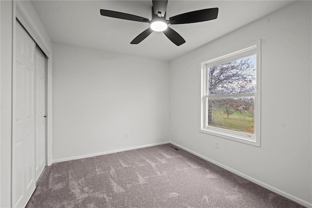 unfurnished bedroom featuring ceiling fan, a closet, and carpet