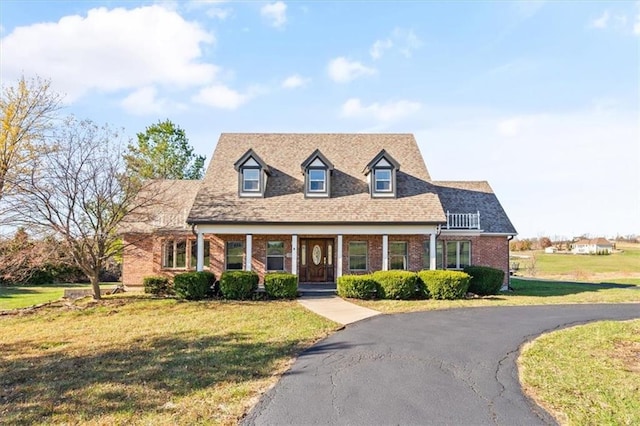 cape cod-style house with a front lawn