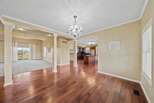 interior space featuring a textured ceiling, dark wood-type flooring, and an inviting chandelier