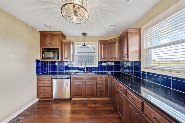 kitchen featuring dishwasher, a healthy amount of sunlight, dark hardwood / wood-style floors, and sink