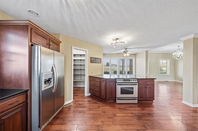 kitchen with dark hardwood / wood-style flooring, a textured ceiling, and appliances with stainless steel finishes