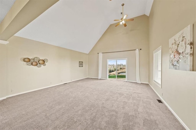 unfurnished living room featuring carpet floors, high vaulted ceiling, and ceiling fan