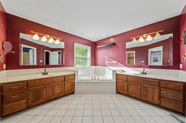 bathroom featuring tile patterned floors, a healthy amount of sunlight, and a textured ceiling