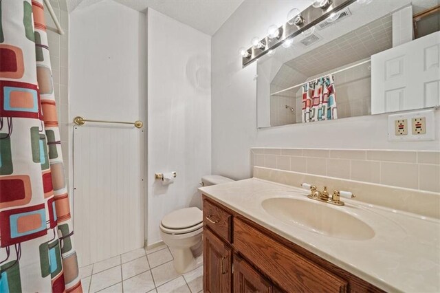 bathroom featuring a shower with curtain, tile patterned floors, backsplash, toilet, and vanity