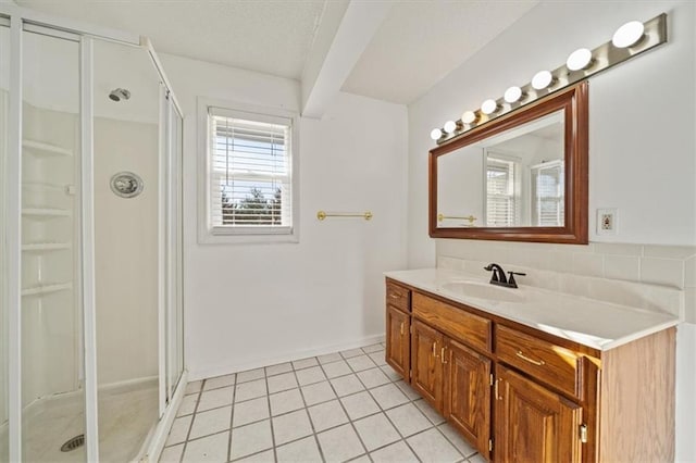 bathroom with tile patterned flooring, vanity, and an enclosed shower