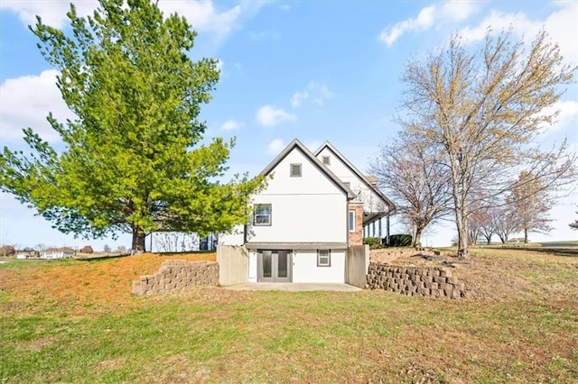 back of house featuring a patio area, a yard, and french doors