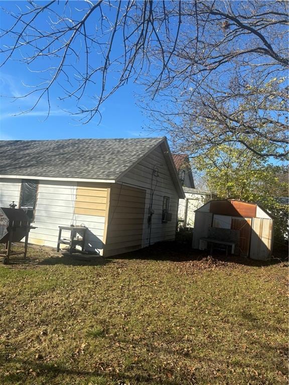 view of side of home with a yard