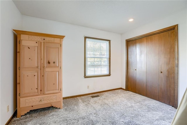 unfurnished bedroom featuring carpet flooring and a closet