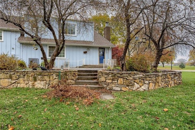 back of house with a lawn