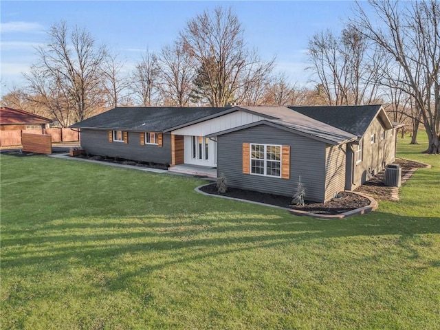 view of front of house with a front lawn and cooling unit