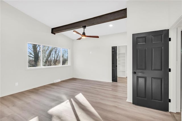 interior space with light wood-type flooring, lofted ceiling with beams, and ceiling fan