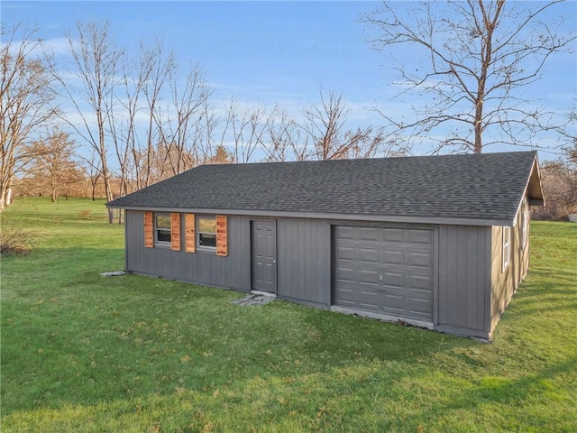 view of outbuilding featuring a yard and a garage