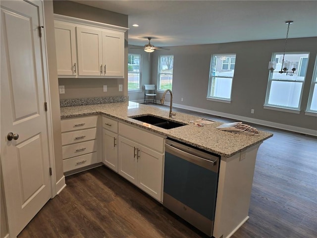 kitchen with dishwasher, kitchen peninsula, sink, and white cabinets