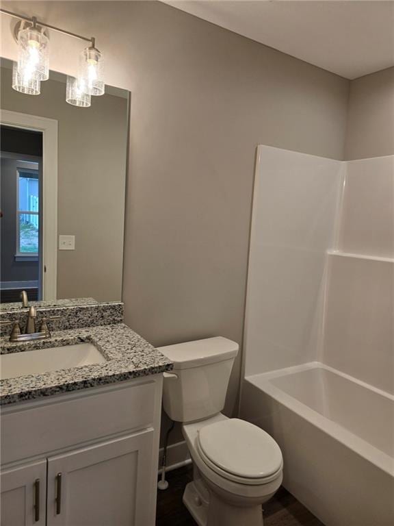 full bathroom featuring  shower combination, vanity, and toilet