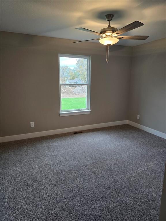 carpeted spare room featuring ceiling fan